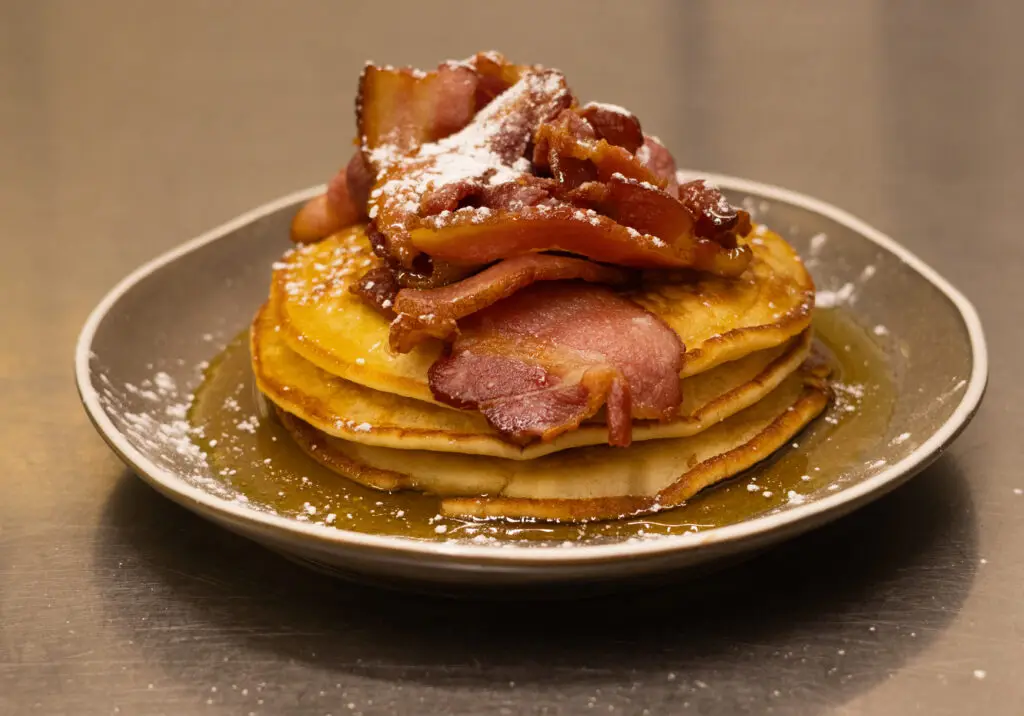 Stack of pancakes with crispy bacon and maple syrup served for breakfast at the Silken Thomas Kildare