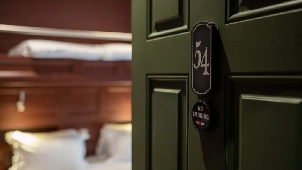 Green panelled bedroom door with room number plaque at Post Master's House, The Silken Thomas, Kildare Town