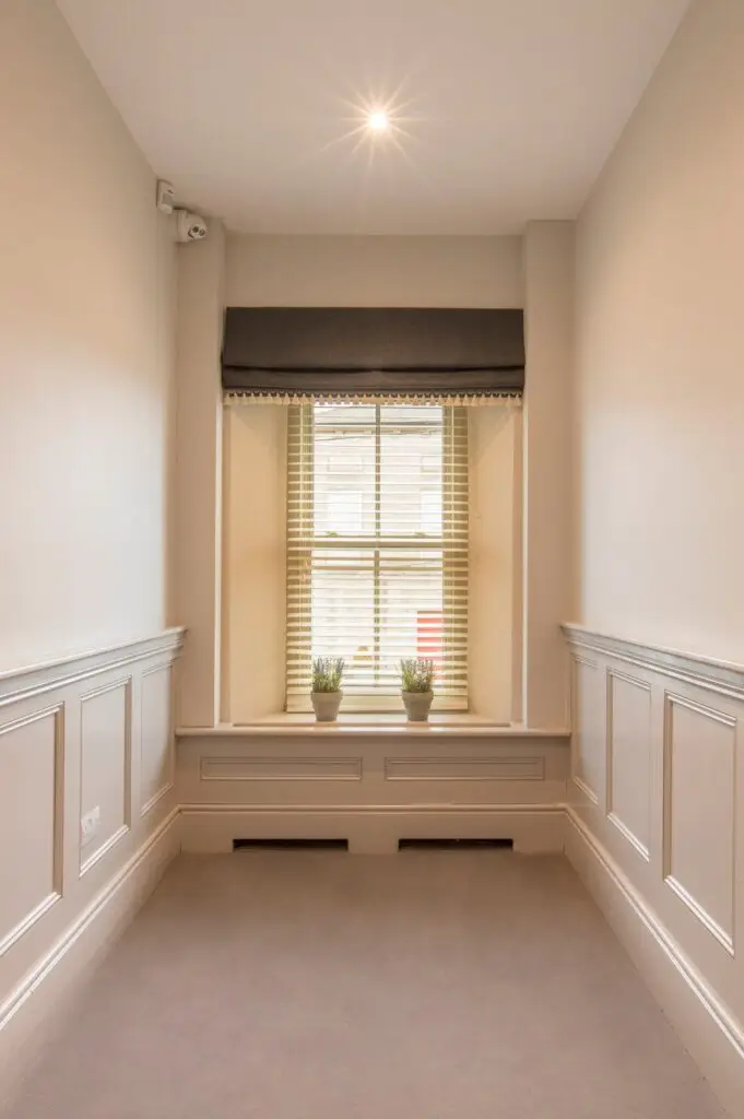 Bright hallway with sash window and panelled walls at Post Master's House, The Silken Thomas, Kildare Town